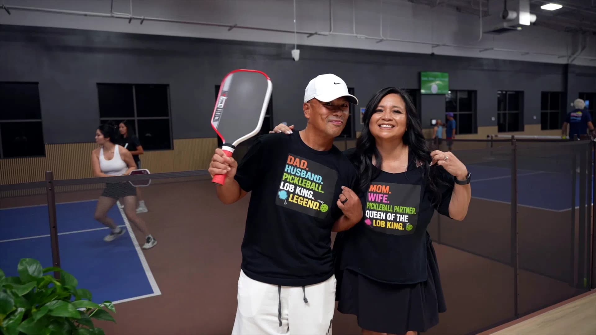 Birthday party guests posing with pickleball paddles at The Courts LV